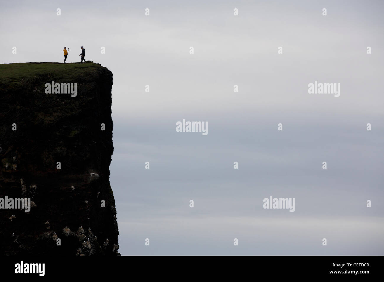 People silhouetted on a cliff, Hafnaberg, Iceland Stock Photo