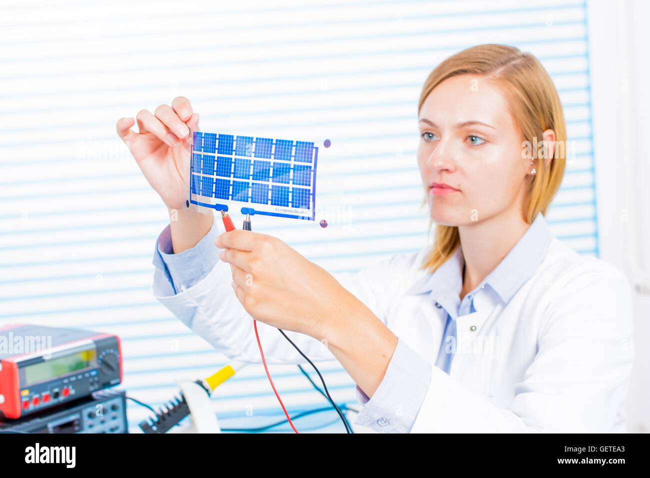 Woman laboratory assistant tests film solar cells Stock Photo Alamy