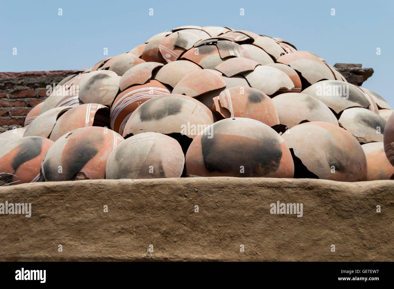 Broken pieces of clay pots stacked together in a village in Rajasthan, India Stock Photo