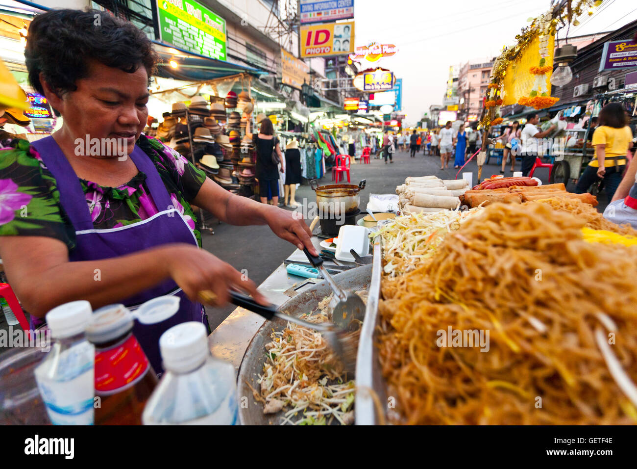 A Thai lady prepares her street food available from food stalls on the Khao San road in Bangkok. Stock Photo