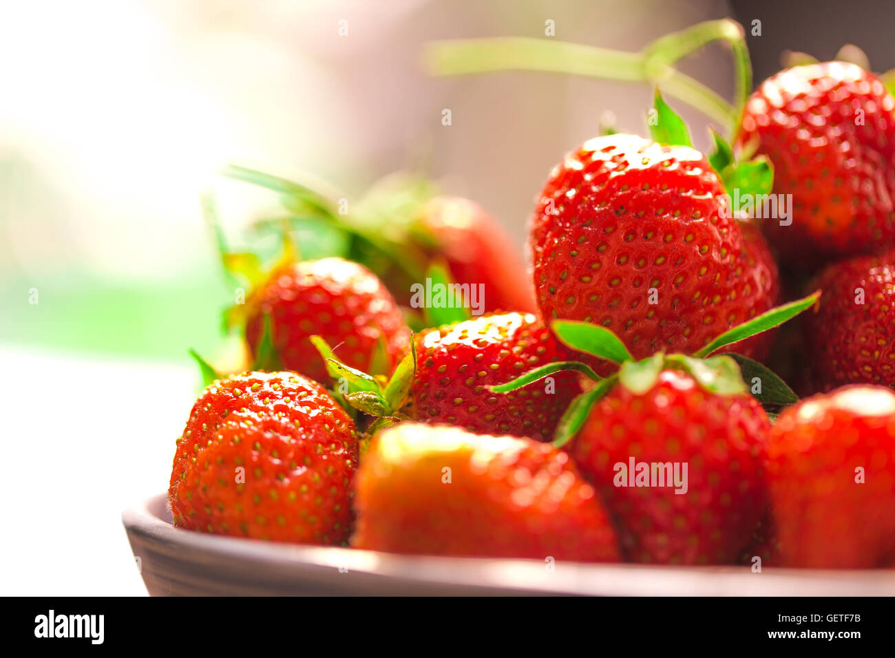 fresh strawberries in a blue plate on a blurred background Stock Photo ...