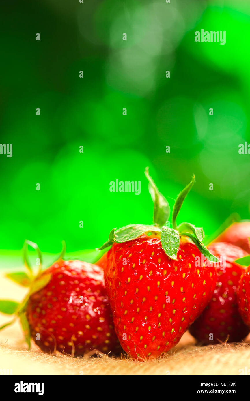 fresh strawberries closeup on the blurry background Stock Photo - Alamy