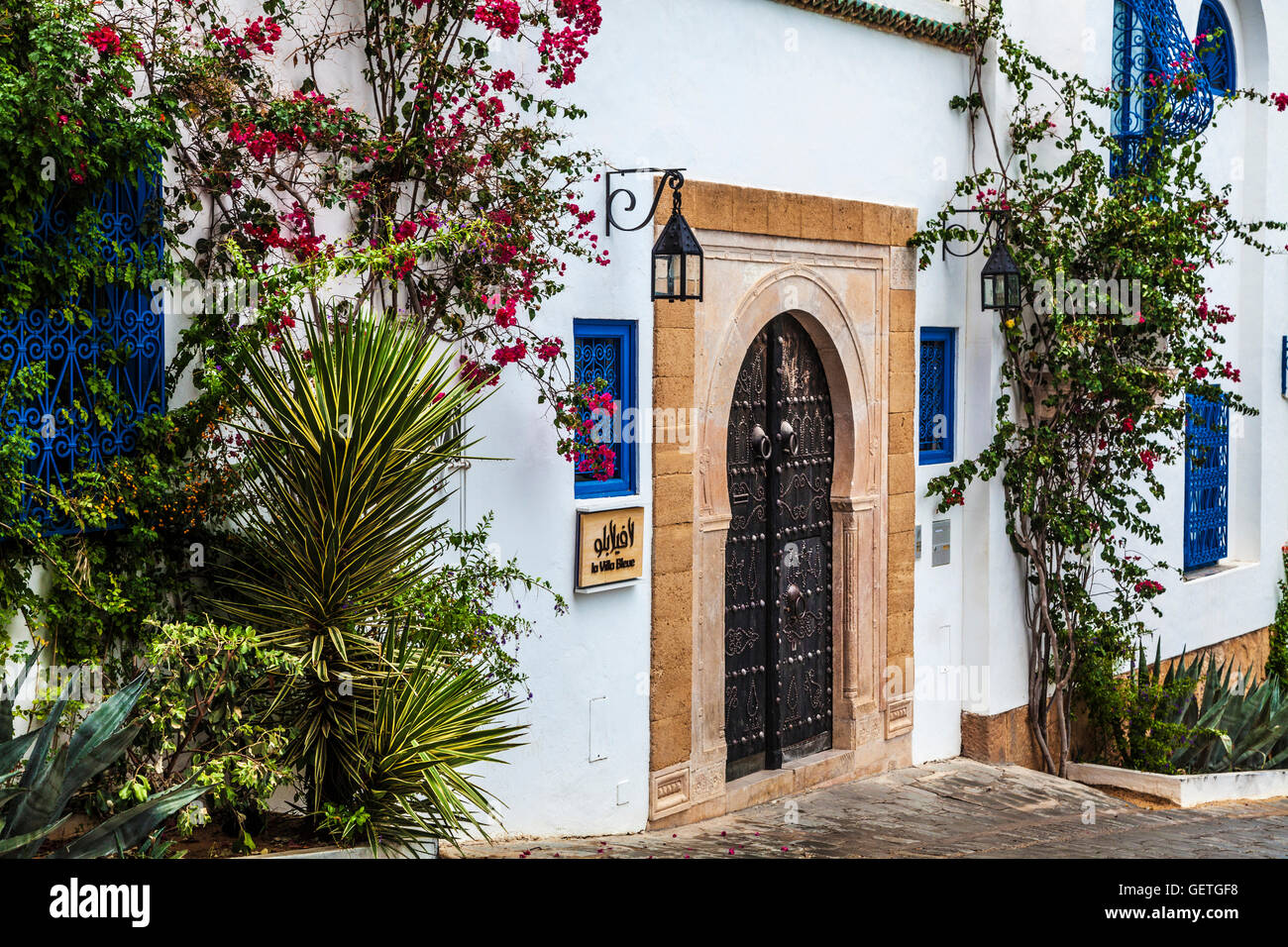 A typical studded wooden door and whitewashed house in Sidi Bou Said in Tunisia. Stock Photo