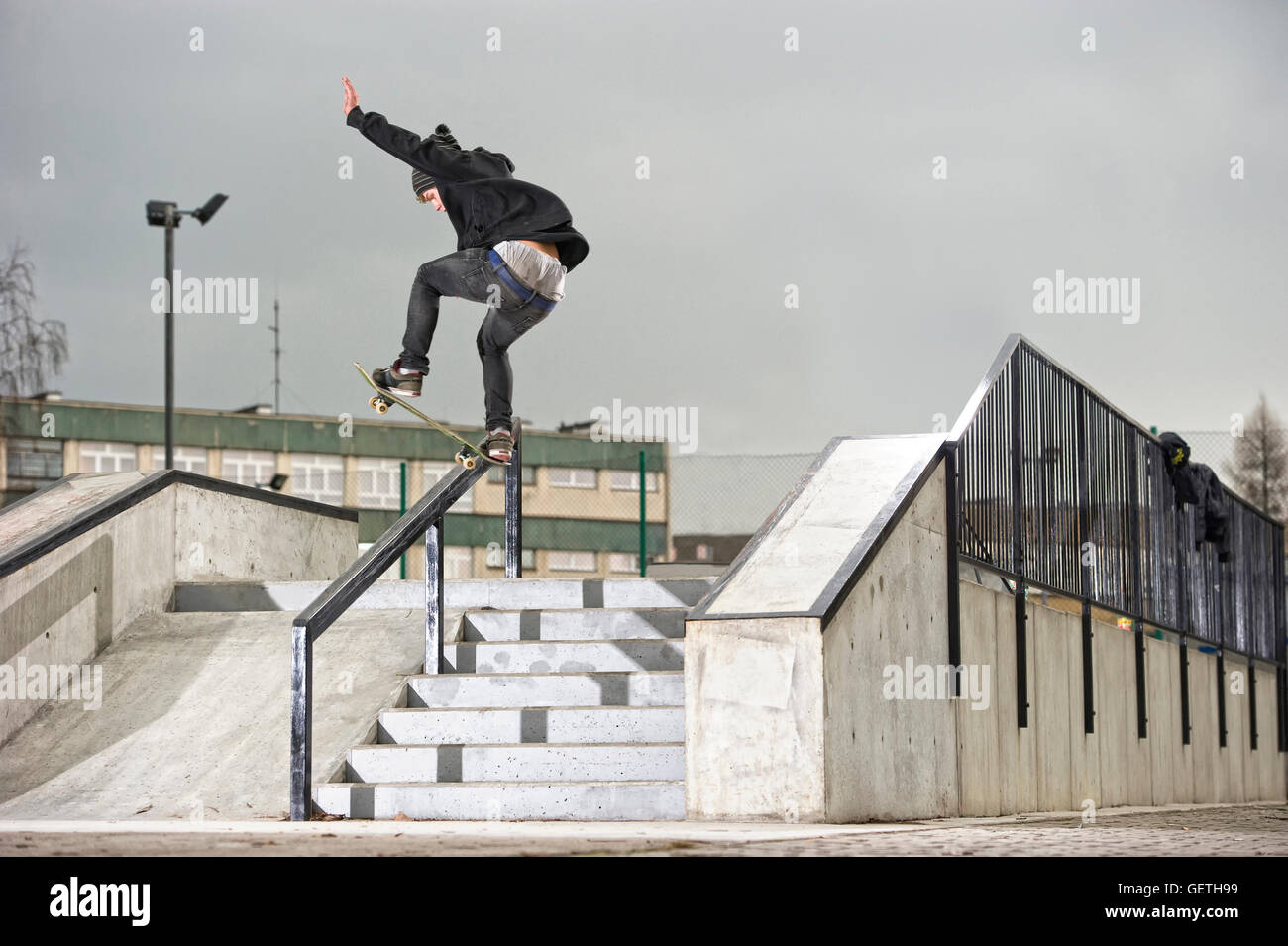 Boy doing skateboard trick on rail Stock Photo Alamy