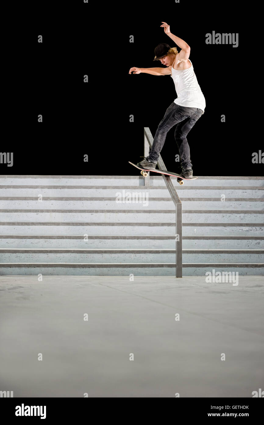 Boy doing skateboard trick on rail Stock Photo Alamy