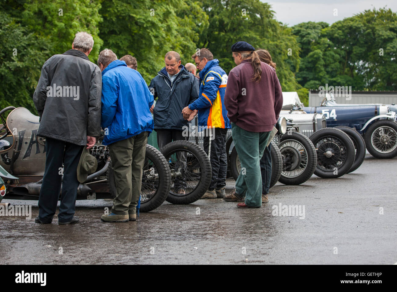 Enthusiasts around vintage racing cars in the paddock at Cadwell Park for a Vintage Sports car club meeting. Stock Photo