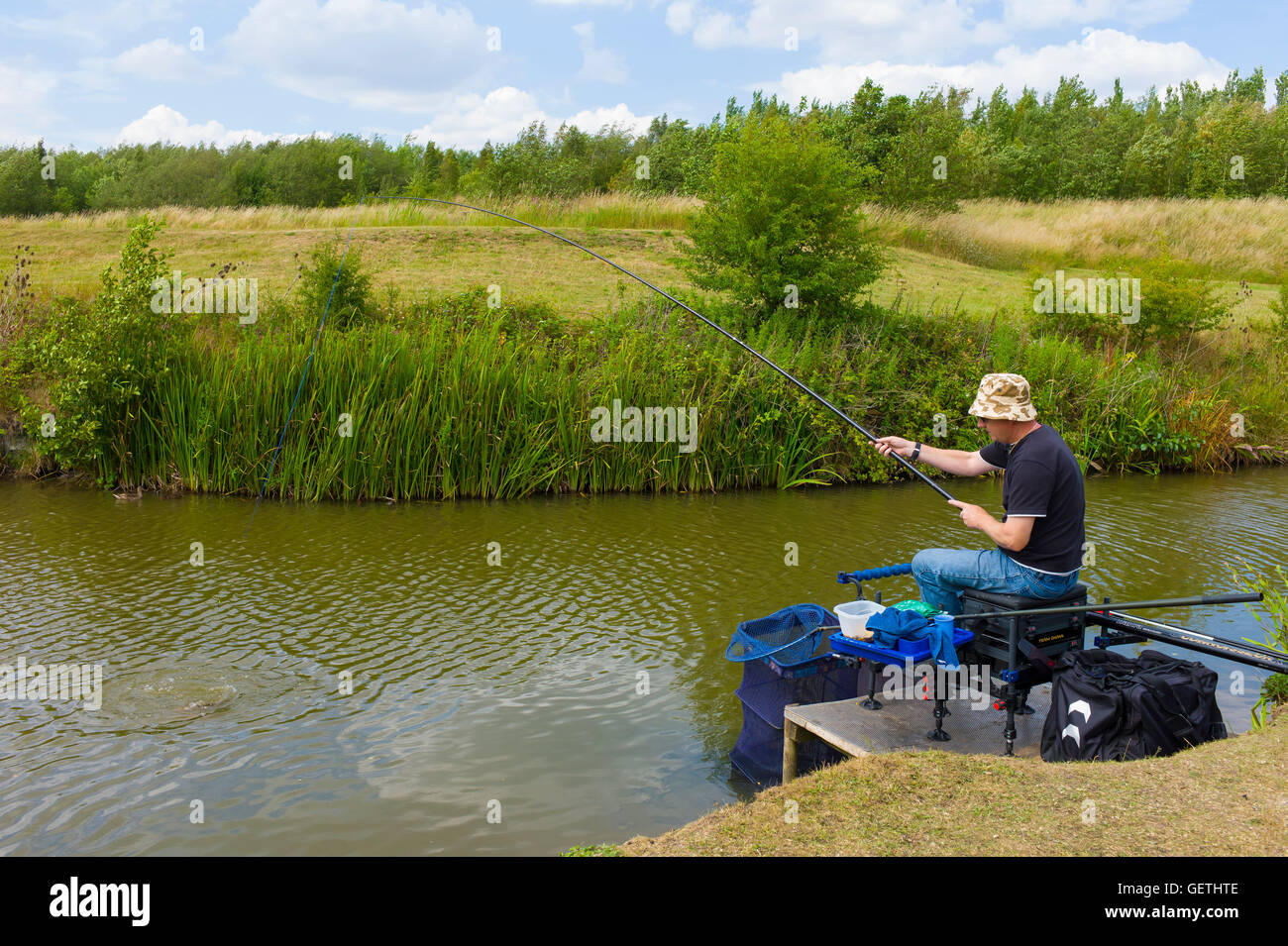 Pole fishing on a lake Stock Photo Alamy