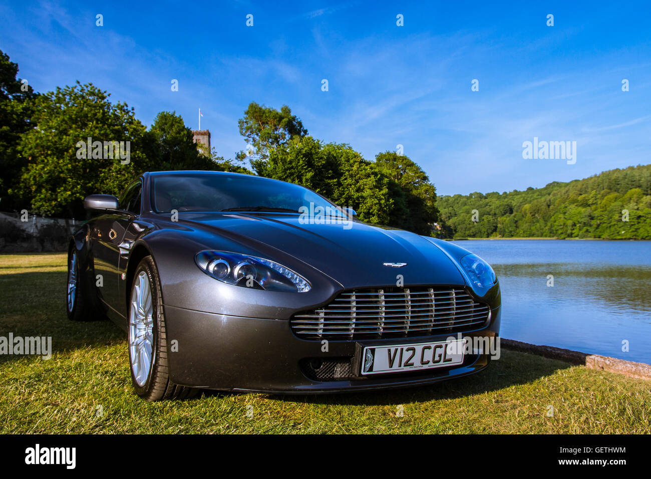 V12 Aston Martin Vantage besides a mill pool. Stock Photo