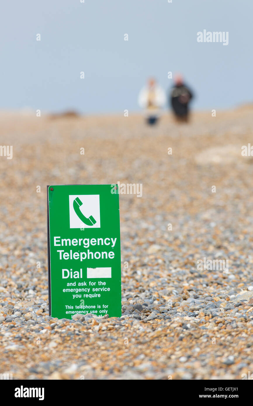 The car park and emergency telephone have been buried under several feet of shingle brought ashore by the winter storms. Stock Photo