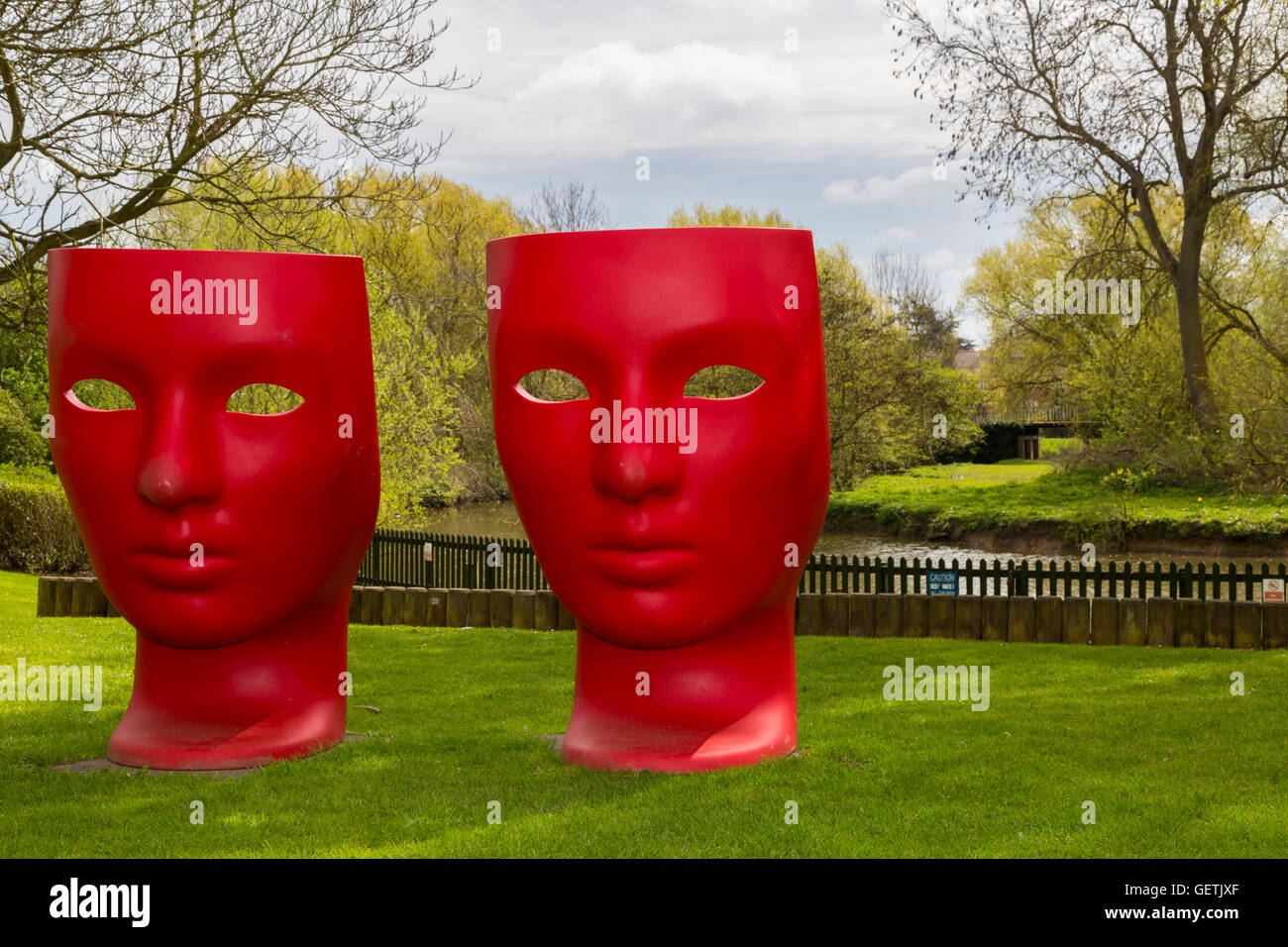 Two unusual red chairs in the form of faces. Stock Photo