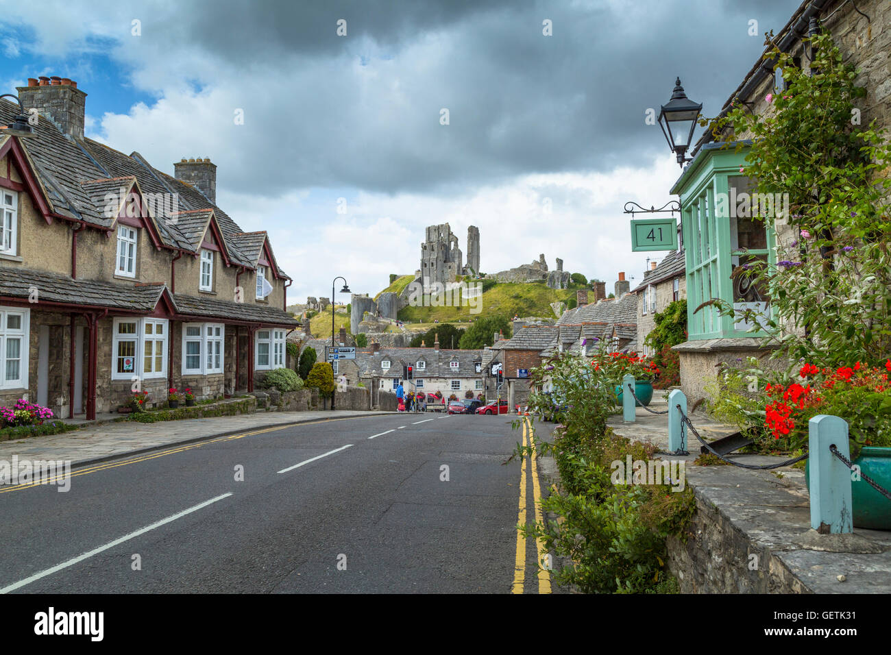 The village of Corfe Castle with the castle itself on the hill beyond. Stock Photo