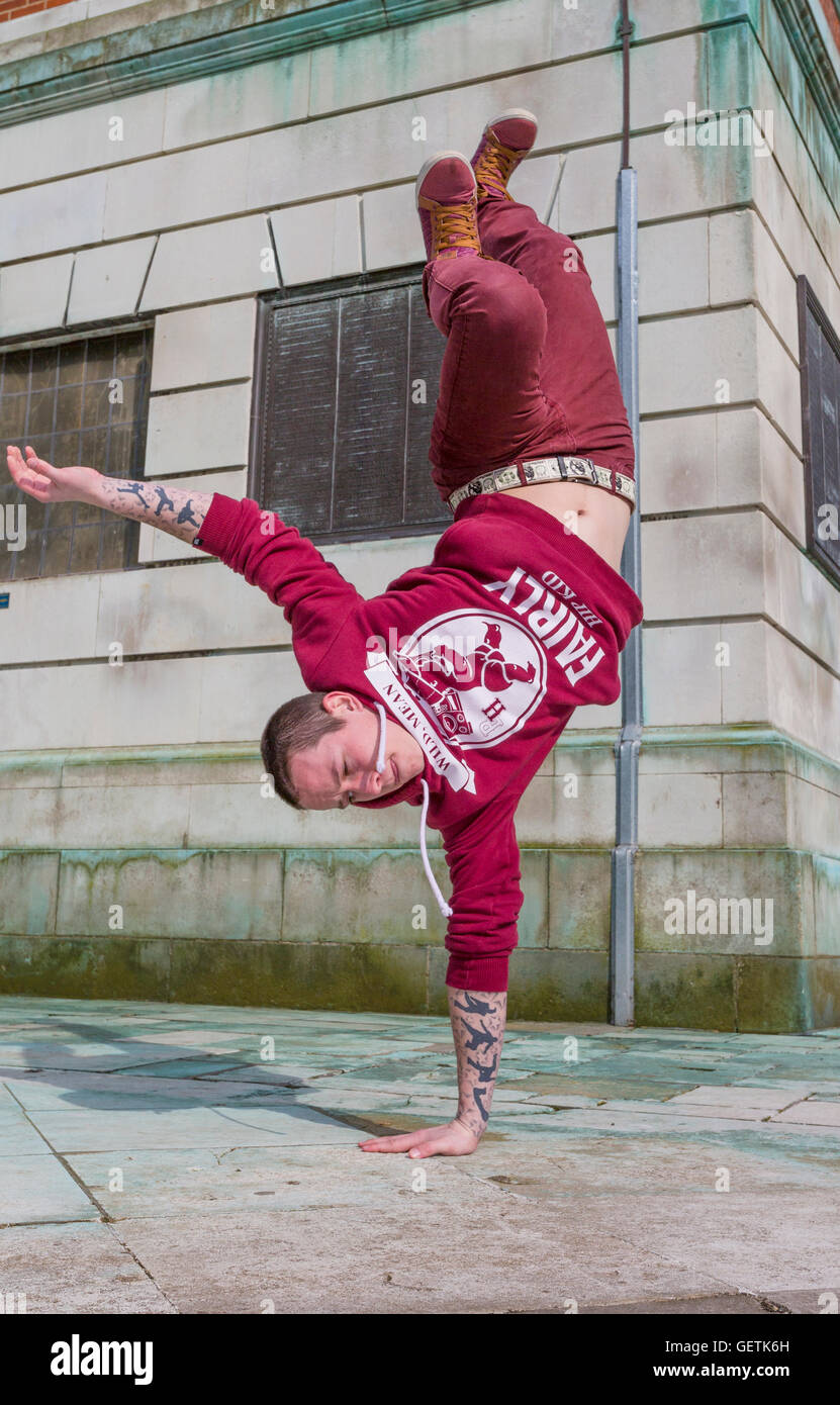 Breakdancer practicing in a public park. Stock Photo