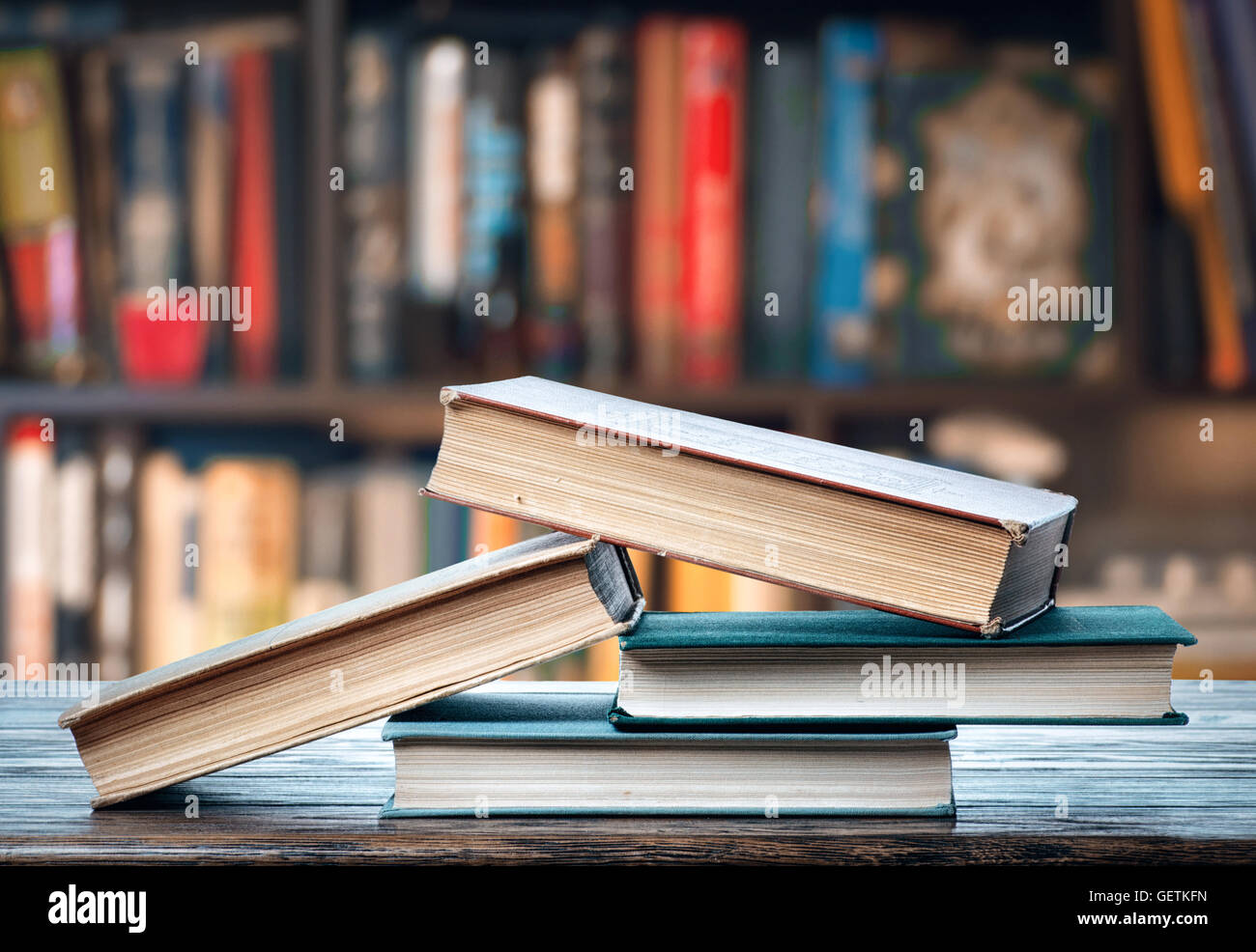 Four books on the table Stock Photo - Alamy