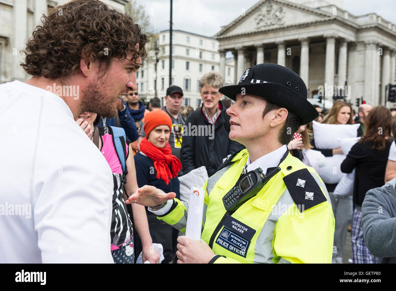 Inspector Walker of the Metropolitan Police tells one of the organisers that the International Pillow Fight Day can go ahead. Stock Photo