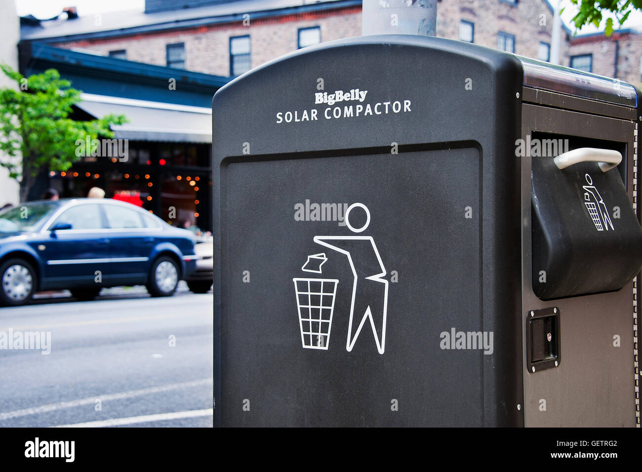 Public solar compactor trash receptacle. Stock Photo