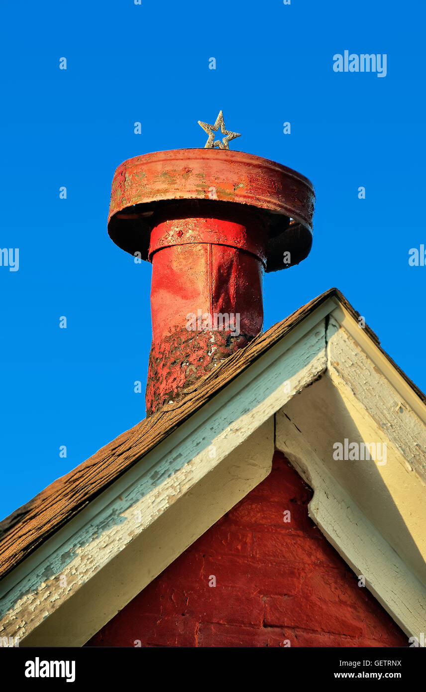 Rustic red chimney with Christmas star. Stock Photo