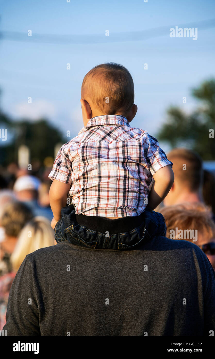 Toddler on fathers shoulders at the rodeo. Stock Photo