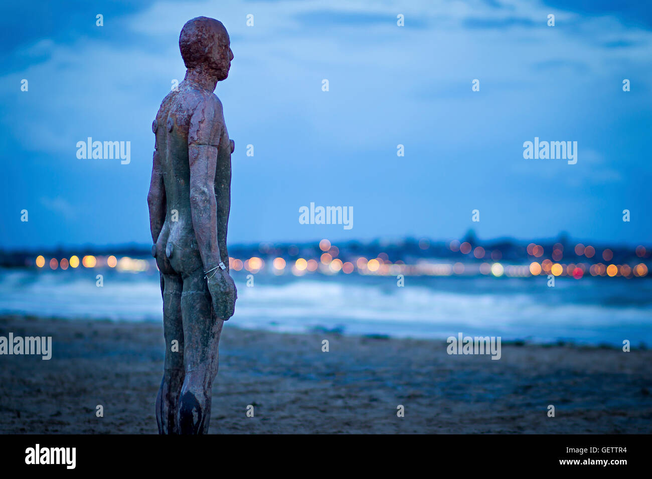 Iron Man statue in the blue hour on Crosby beach Stock Photo Alamy
