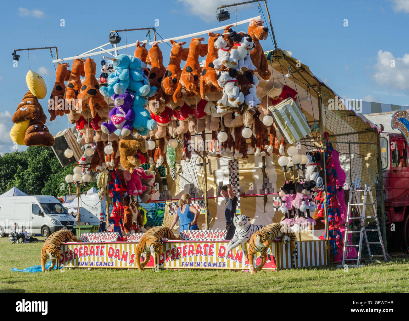 A 'tin can alley' game at a fairground Stock Photo Alamy