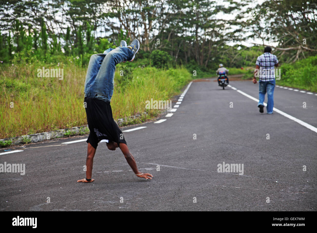 A man spontaneously works on his hands in Mauritius Stock Photo