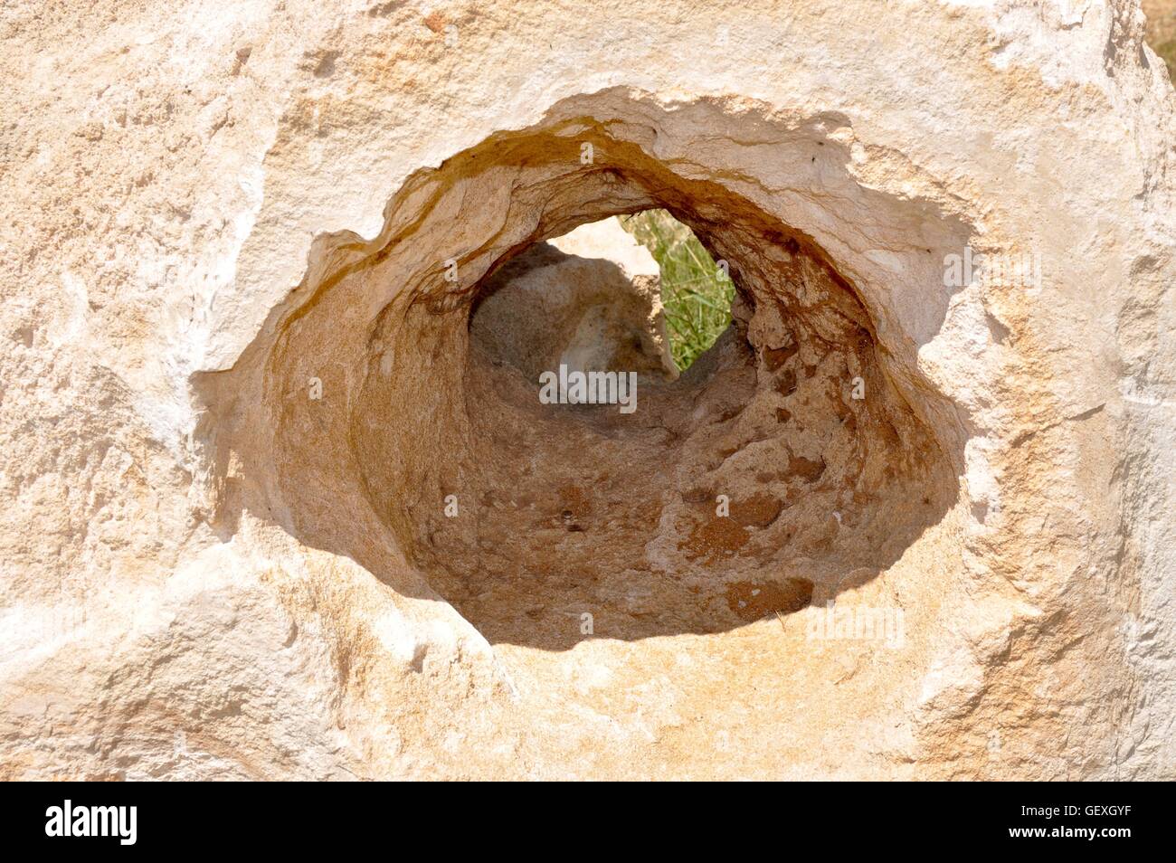Closeup of textured limestone rock with natural hole in Western ...