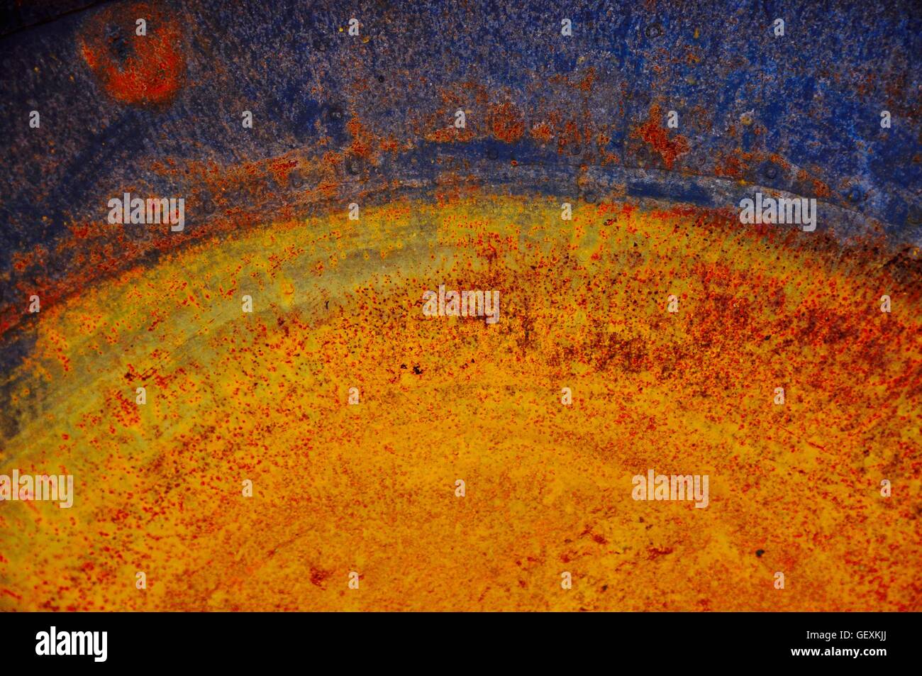 Abstract closeup of brightly colored and rusted paella pan Stock Photo