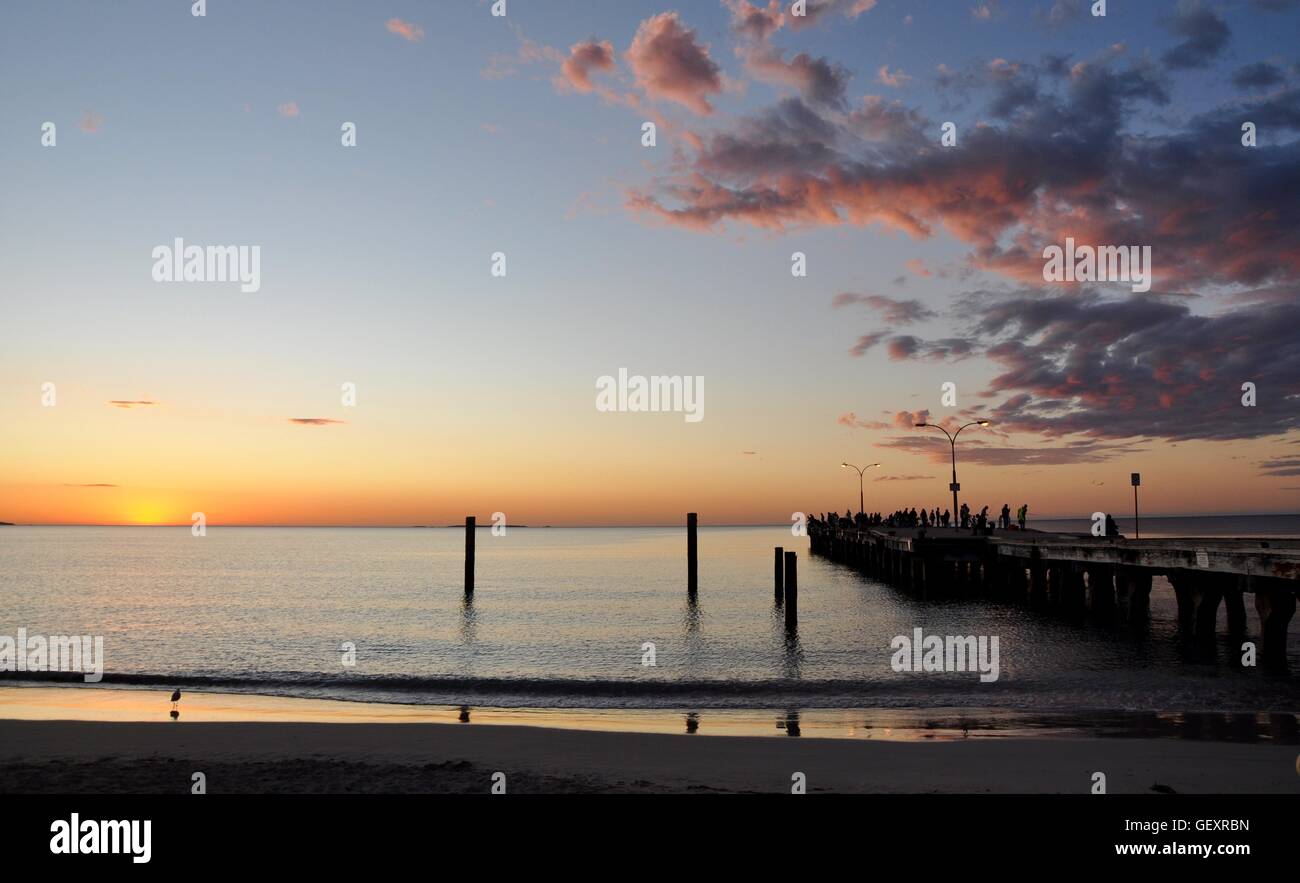 Coogee,WA,Australia-October 25,2015:Jetty in diminishing perspective with people at Coogee Beach with sunset in Coogee, Western Australia Stock Photo