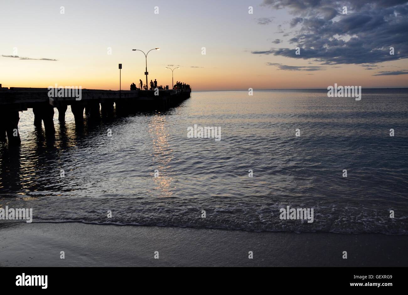 Coogee,WA,Australia-October 25,2015:Indian Ocean jetty with people in silhouette and the colourful sunset at Coogee Beach in Coogee, Western Australia Stock Photo
