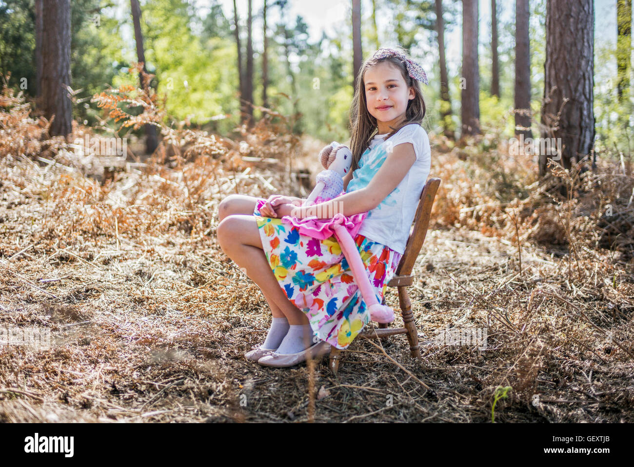 A young girl playing in the woods Stock Photo - Alamy