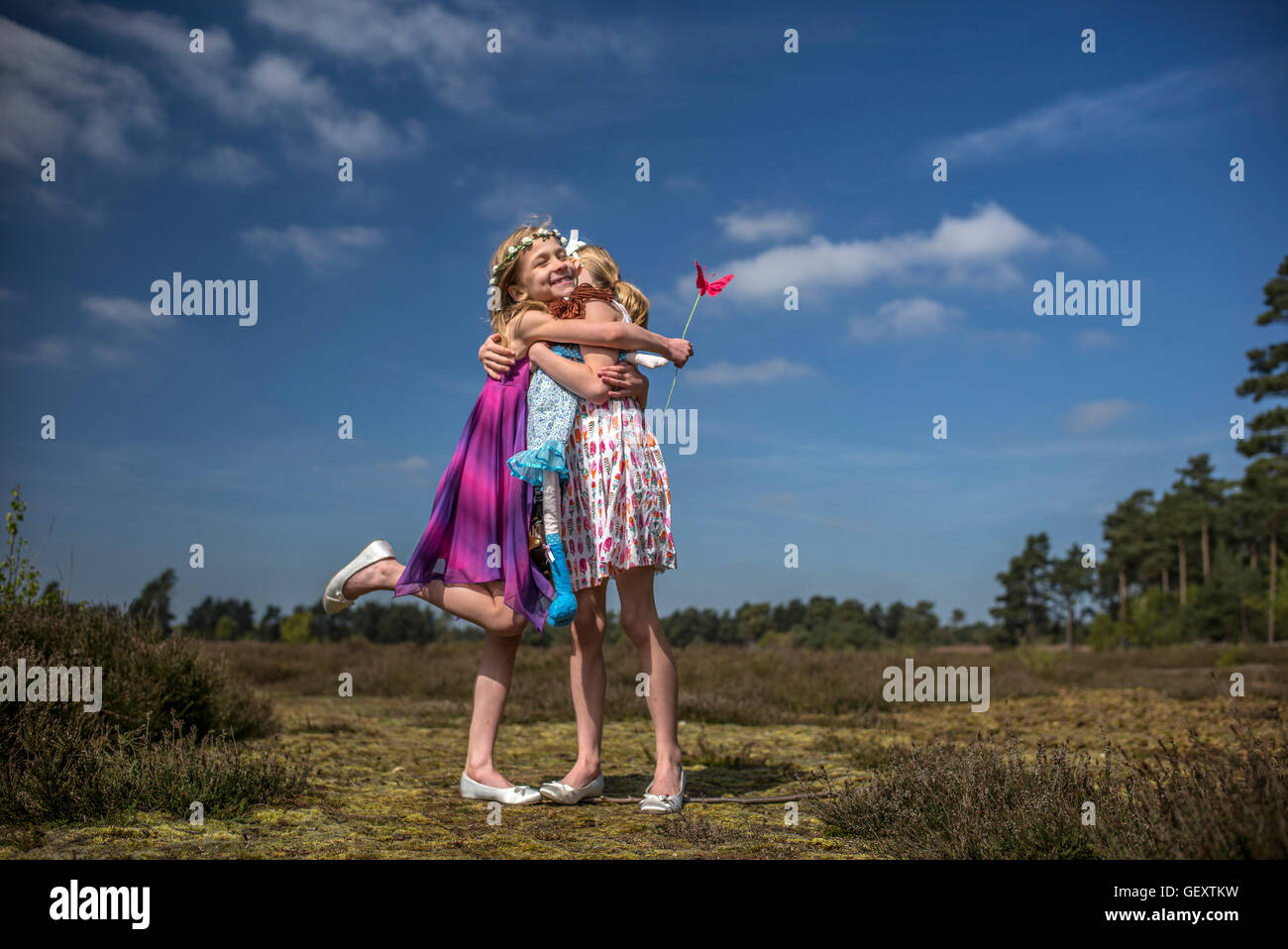 Identical twin sisters play together in the open air. Stock Photo