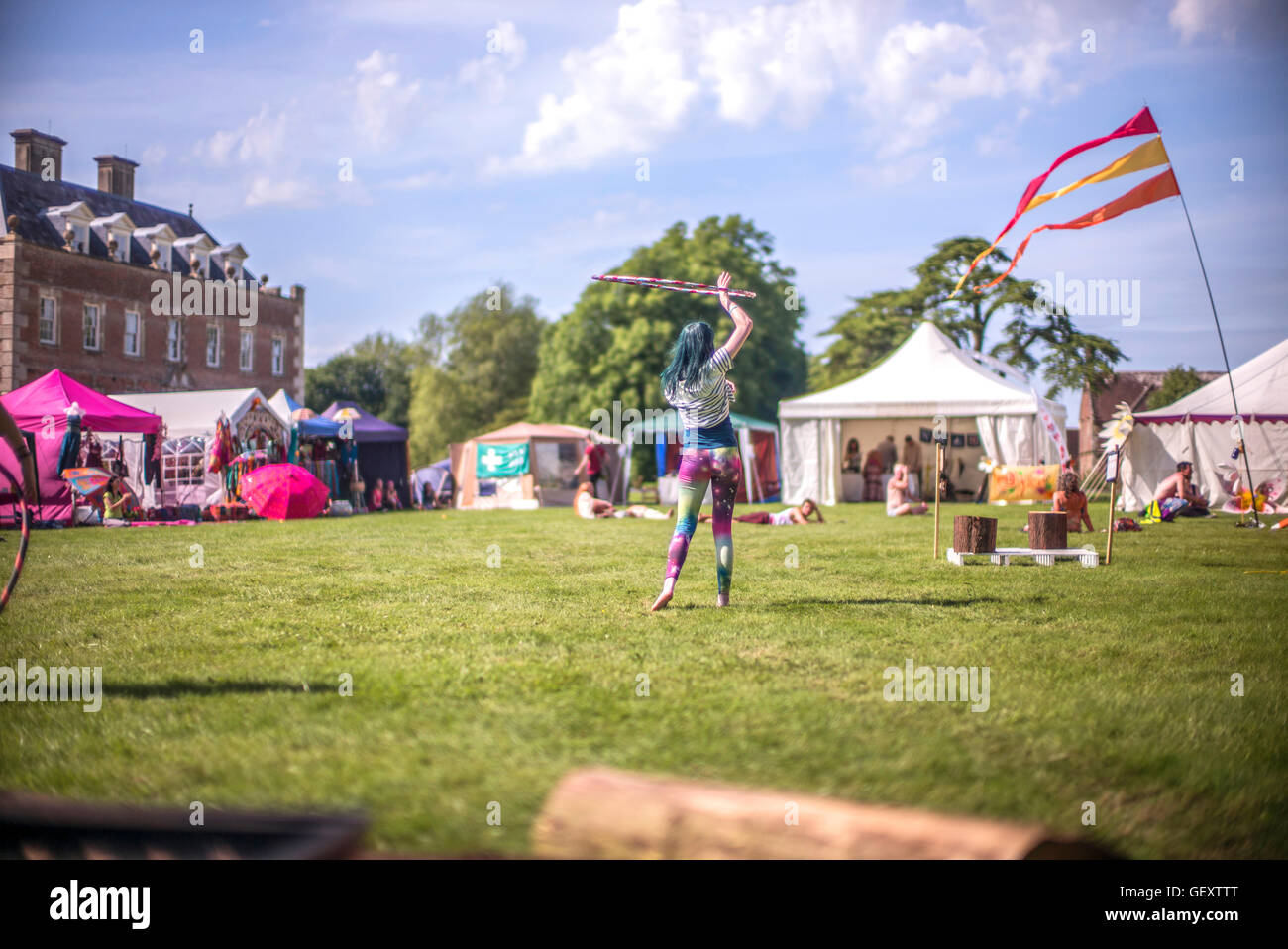 A girl twirling a hula hoop at the Colourfest Festival at St Giles House in Dorset. Stock Photo