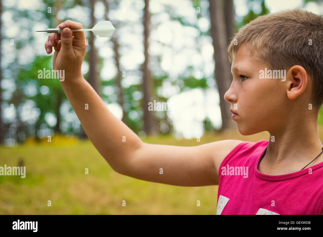 Portrait child outdoors. Teen takes aim Stock Photo - Alamy