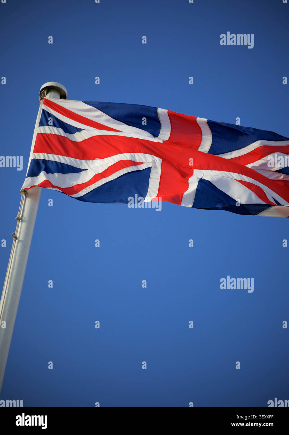 The Union Jack flag against a blue sky Stock Photo - Alamy