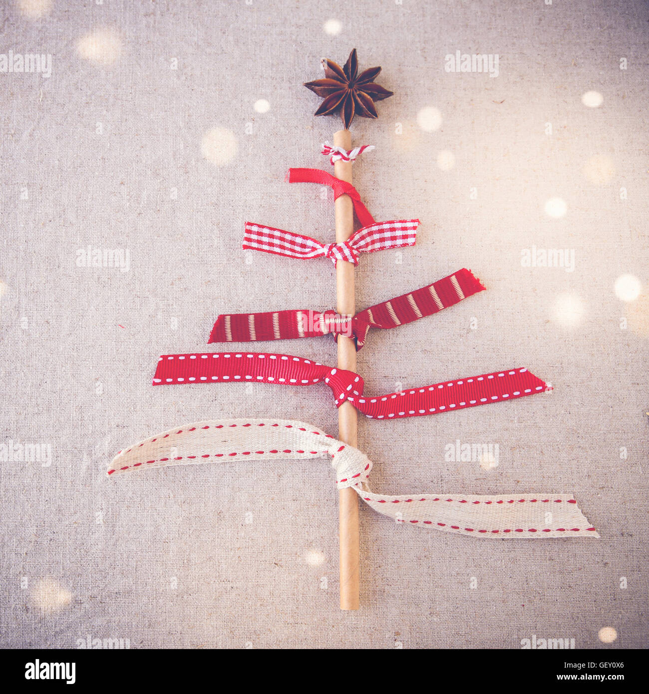 made from ribbons, eco straw and anise star, fairy light and toning background Stock Photo