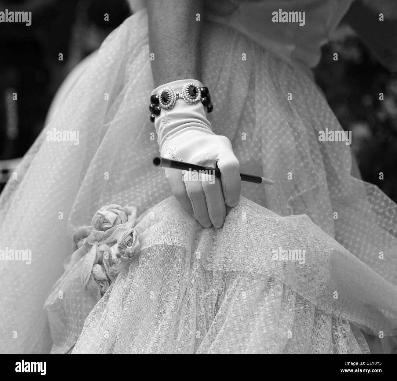 white glovers of an elegant lady with the cigarette holder and vintage style dress Stock Photo