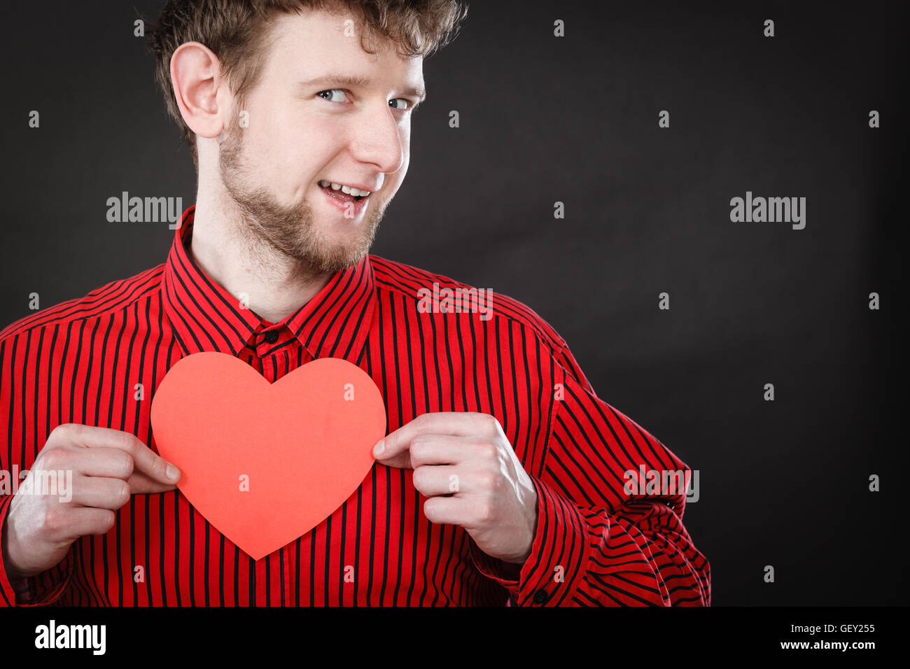 Feelings affection happiness concept. Cheerful man holding heart ...