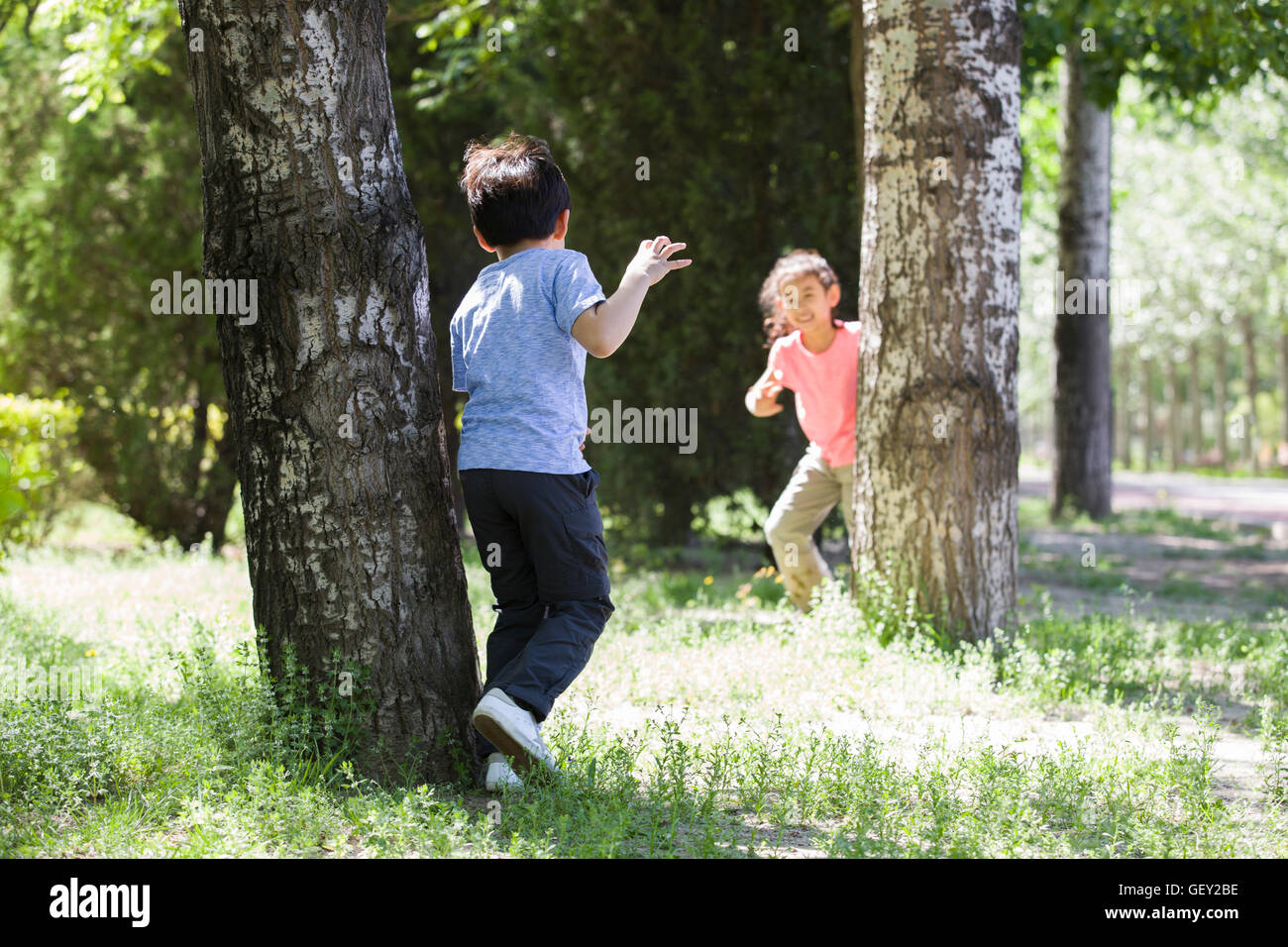 Happy Chinese children playing in woods Stock Photo - Alamy