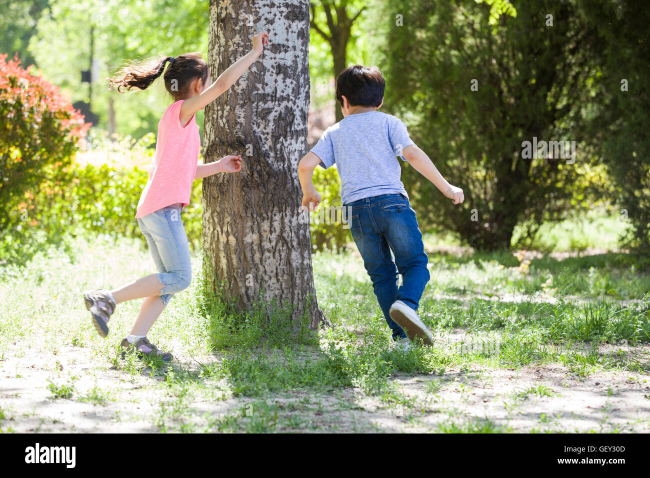 Happy Chinese children playing in woods Stock Photo - Alamy