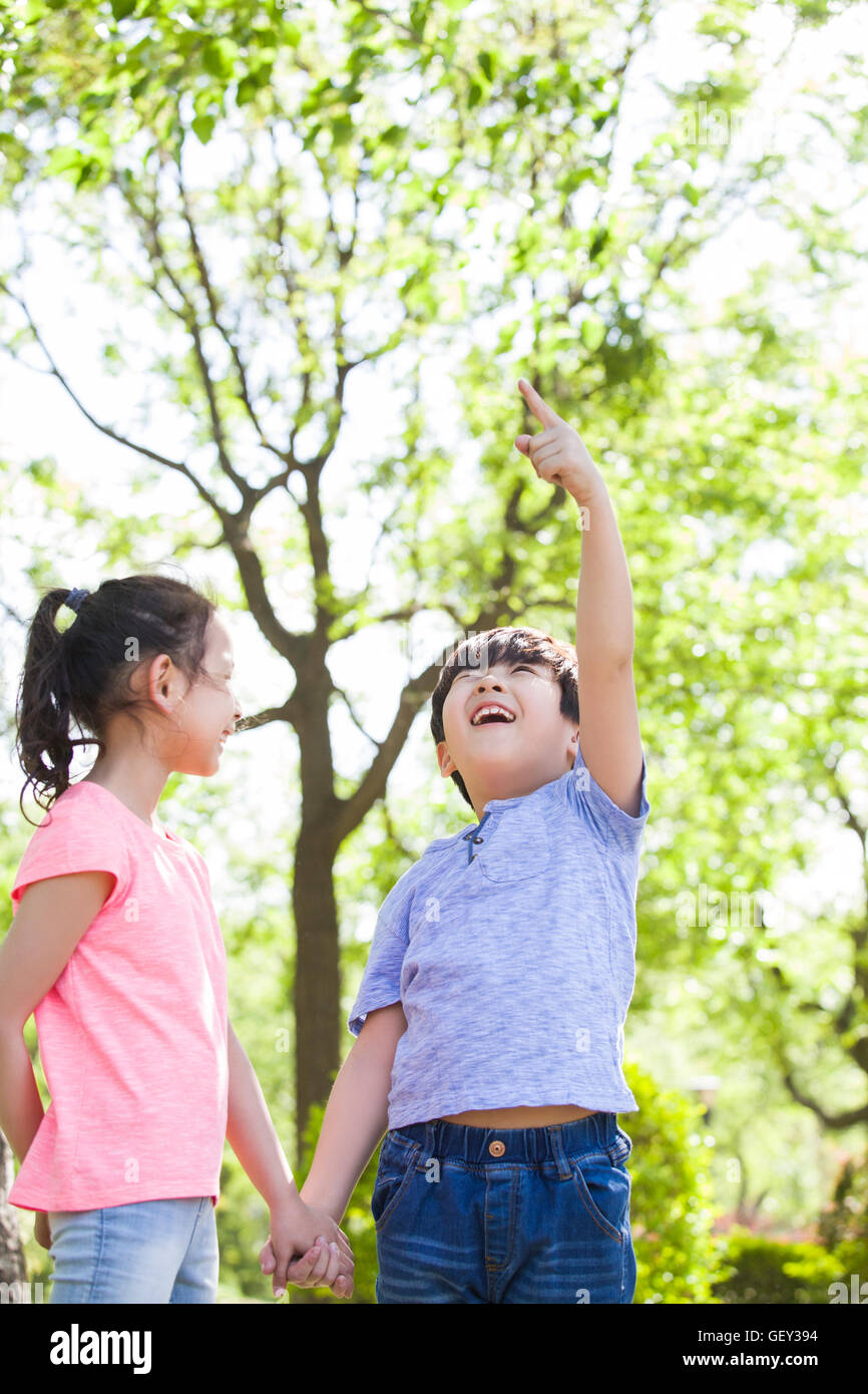 Happy Chinese children playing in woods Stock Photo - Alamy