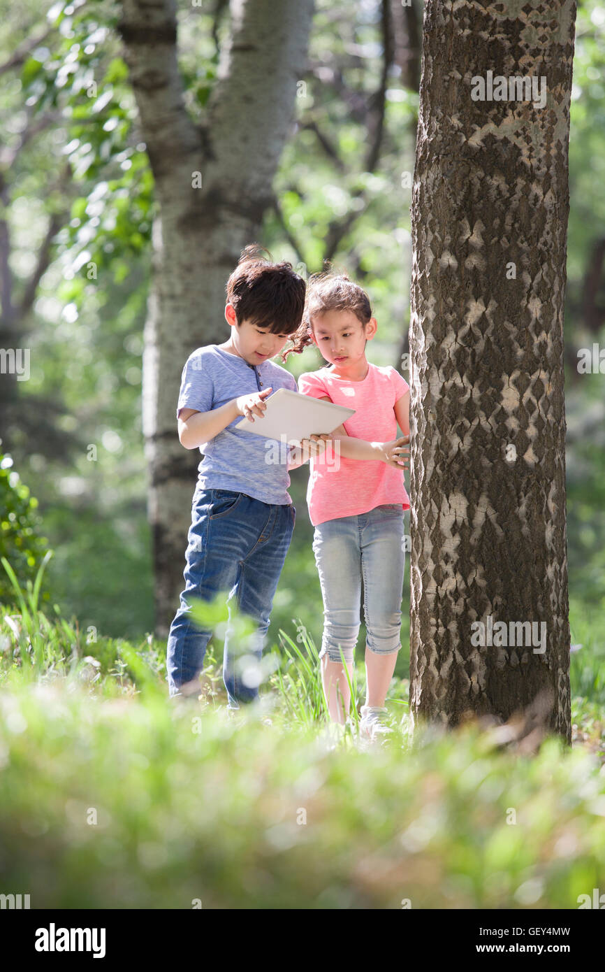Happy Chinese children playing in woods Stock Photo - Alamy