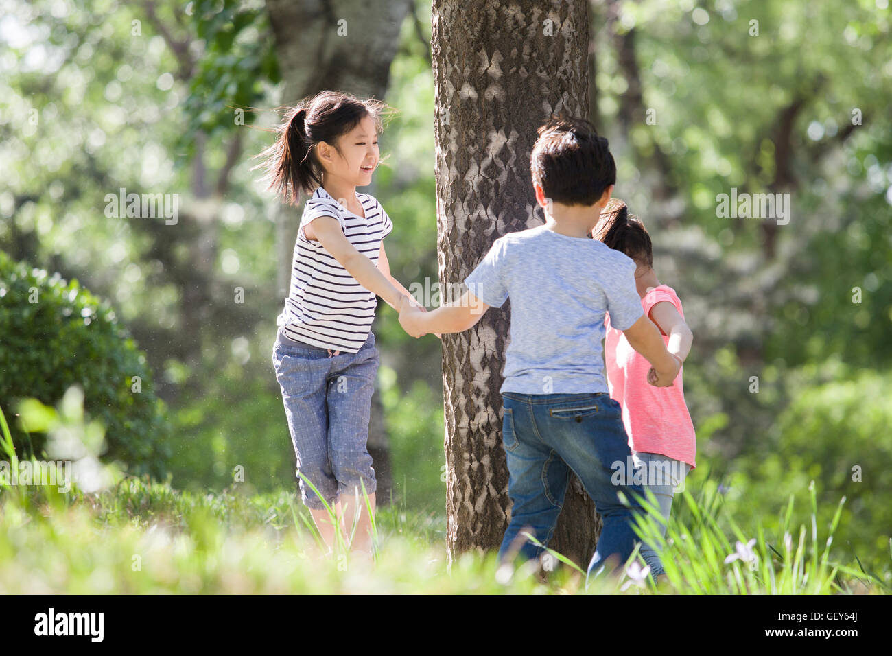 Happy Chinese children playing in woods Stock Photo - Alamy