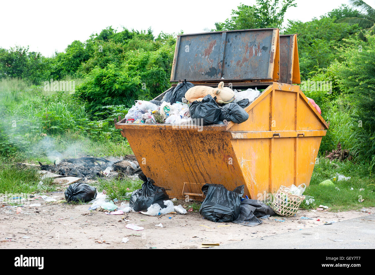 yellow dumpster with household garbage Stock Photo Alamy