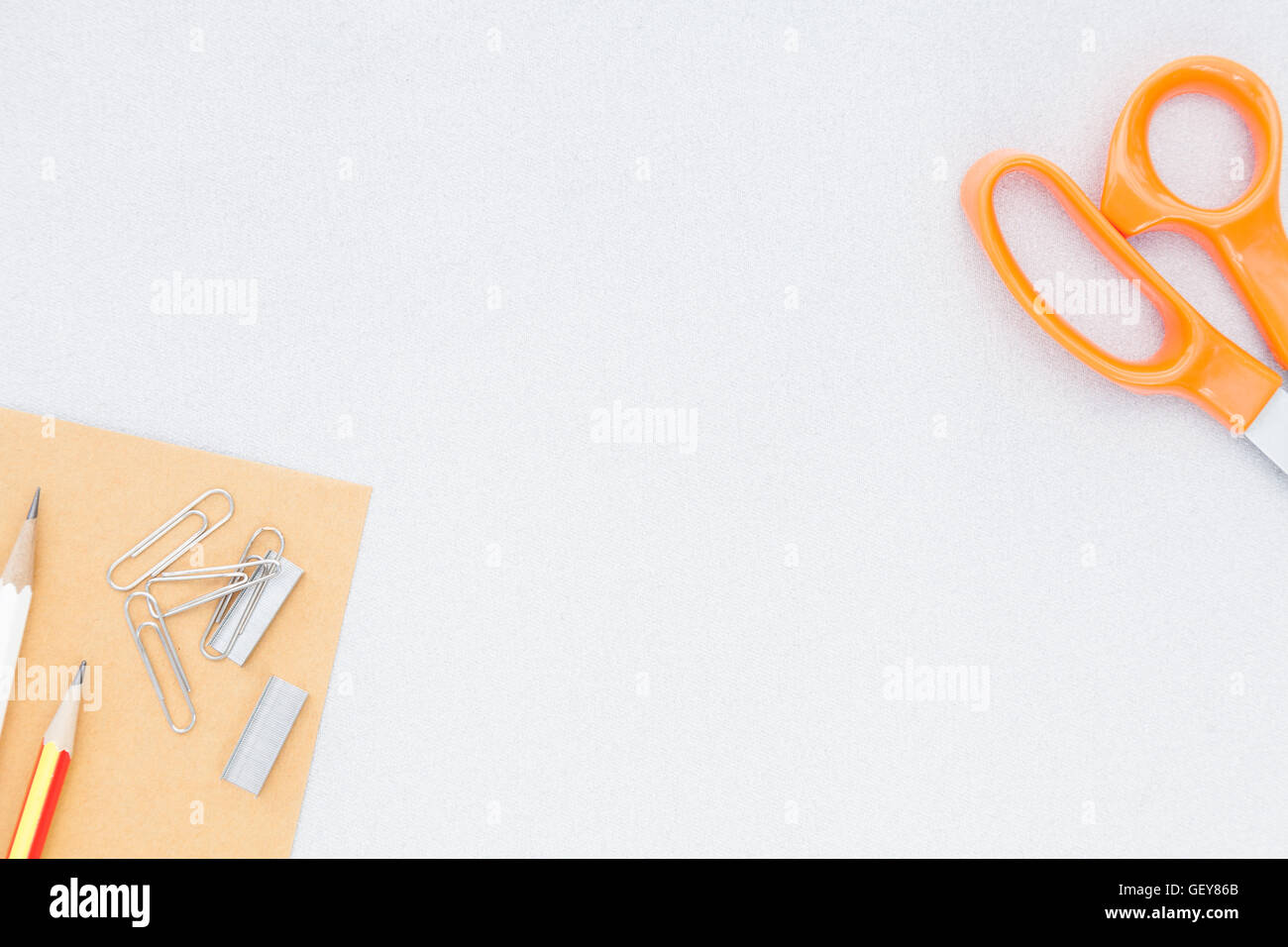pencil clip staples and scissors placed on gray background, leave space