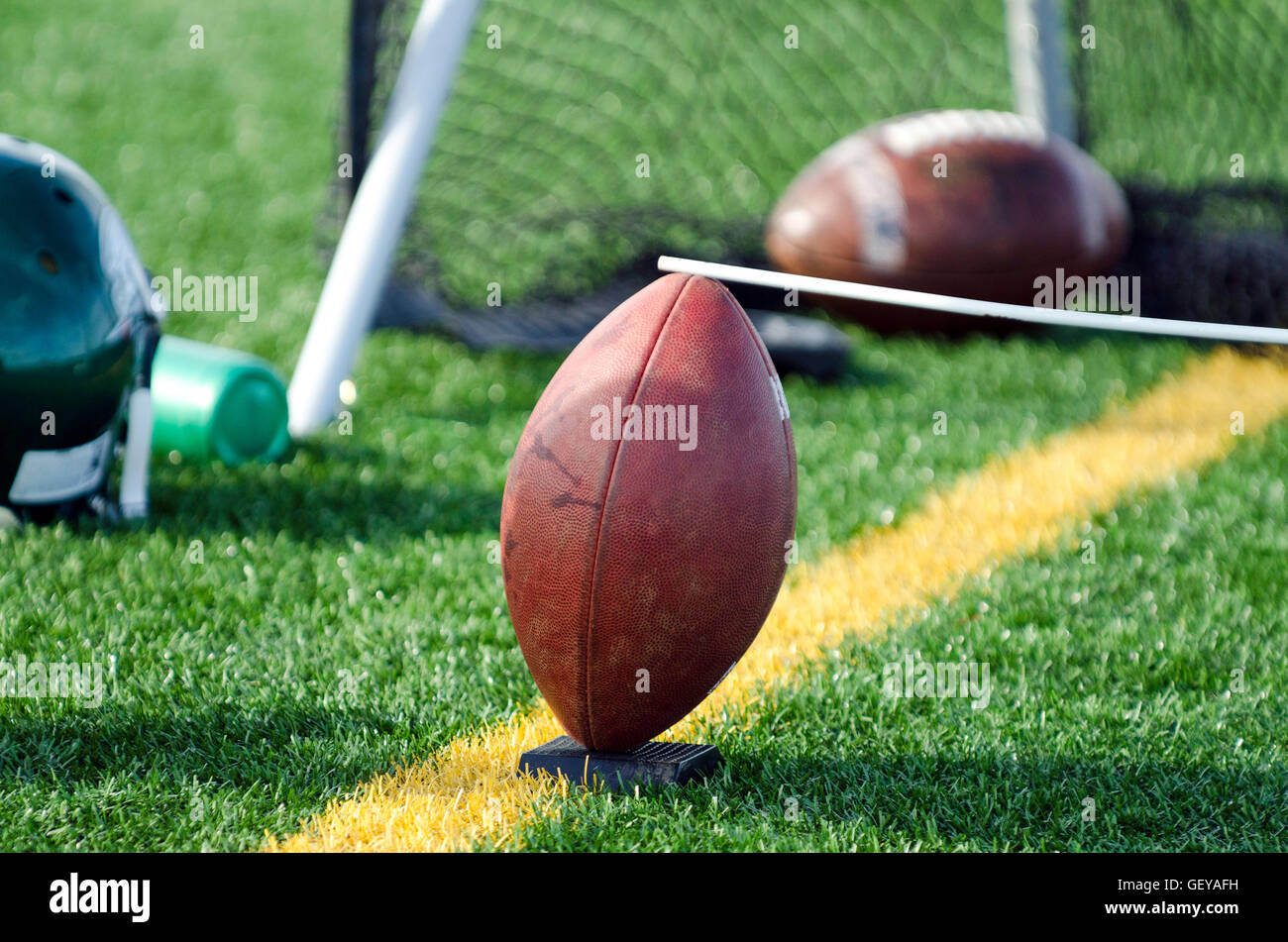 Football with holder for kicking Stock Photo Alamy