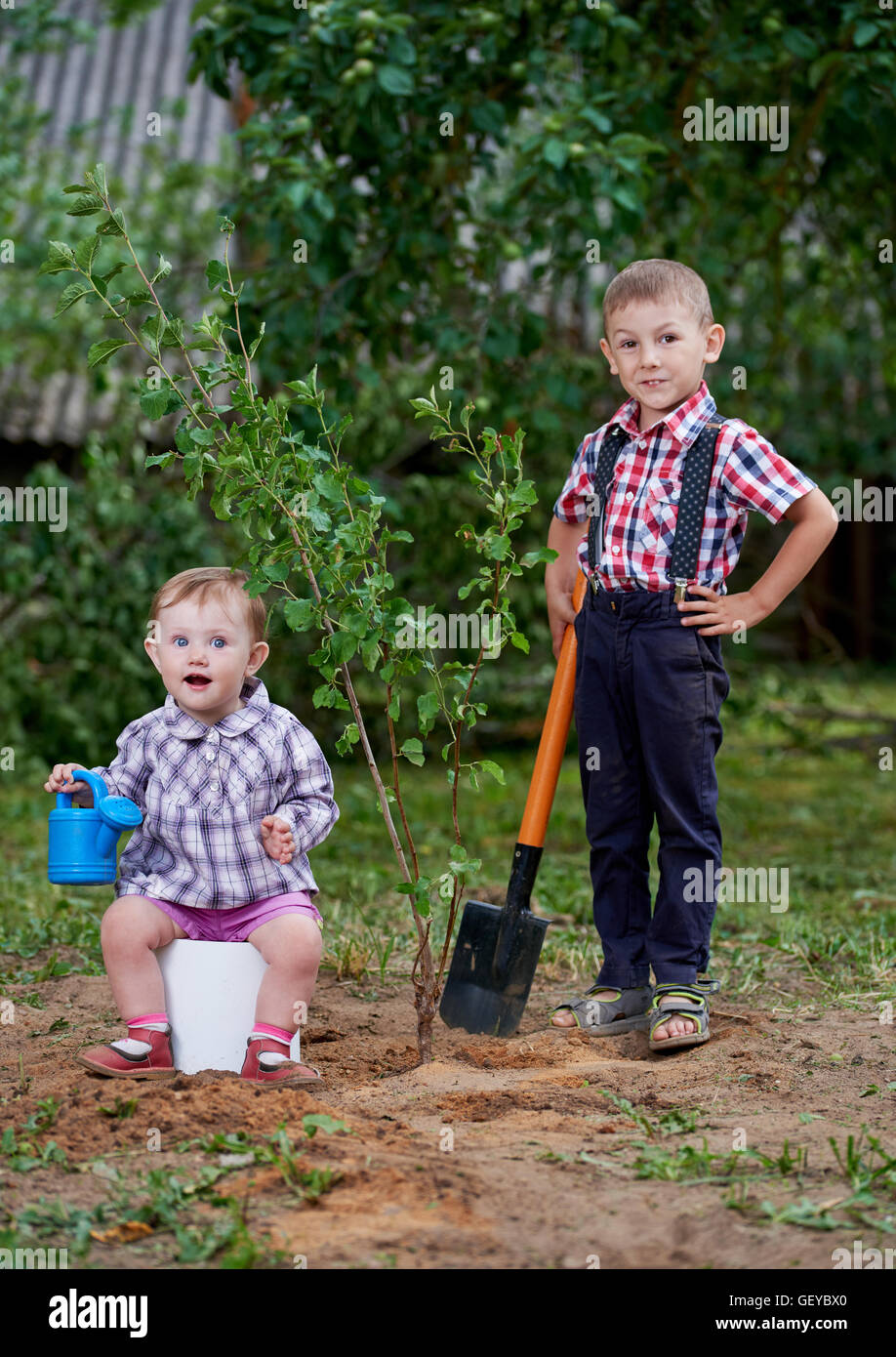 funny boy with shovel in garden Stock Photo - Alamy