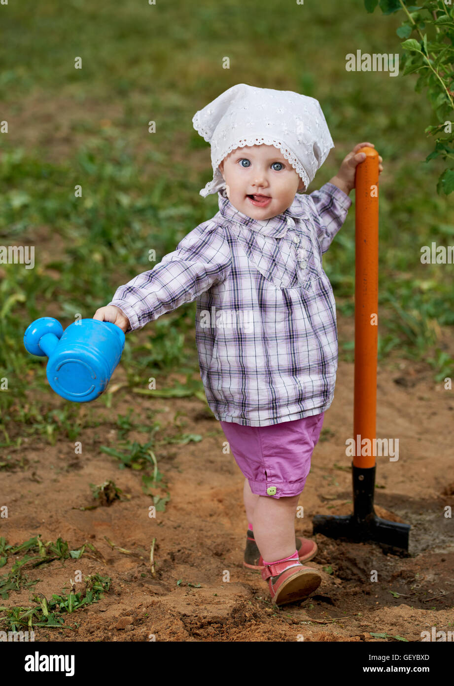 funny boy with shovel in garden Stock Photo - Alamy