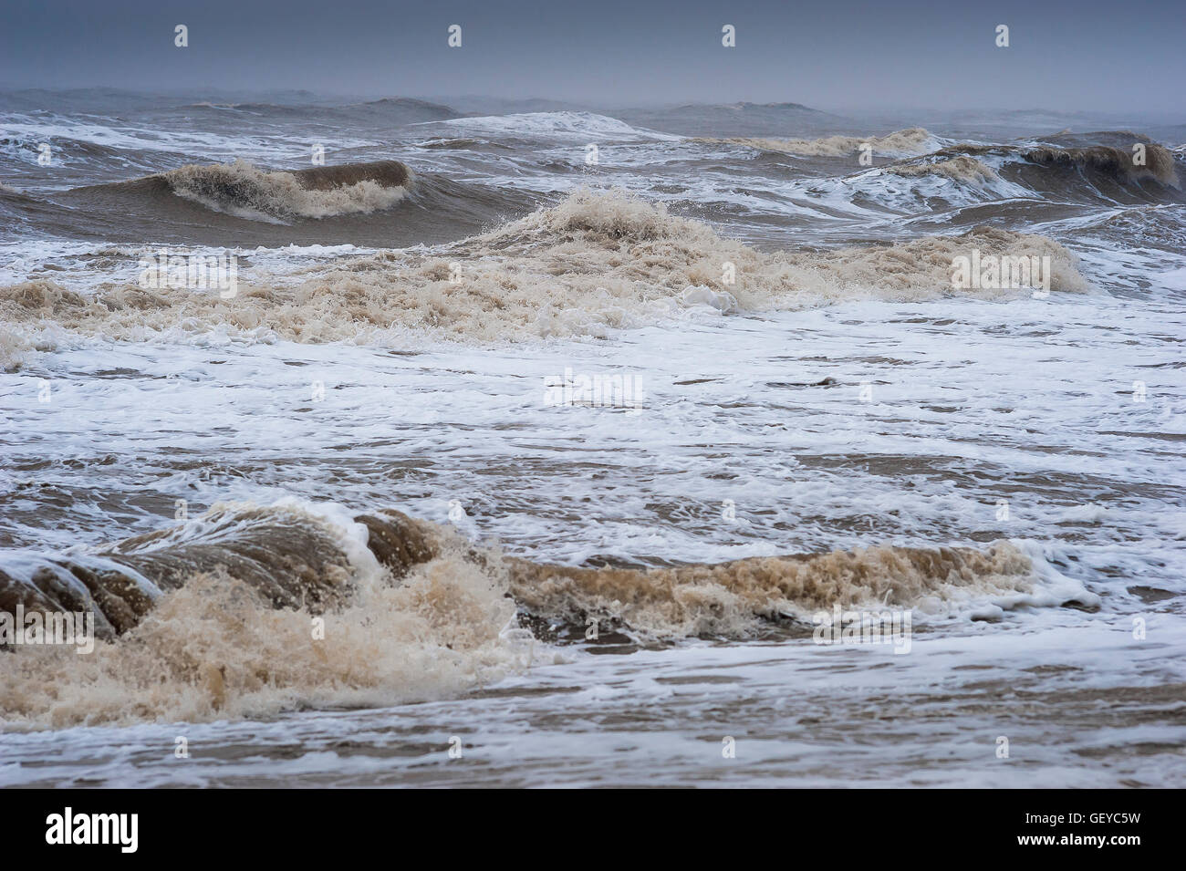 Beach stormy sea, view of a stormy North Sea breaking waves against the Suffolk coast at Thorpeness, England. Stock Photo