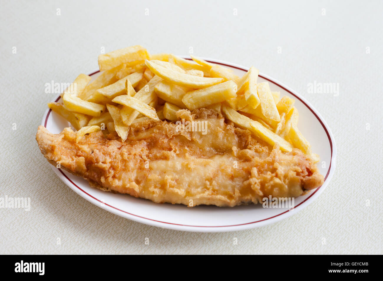 Traditional english meal deep fried fish, haddock with chips served