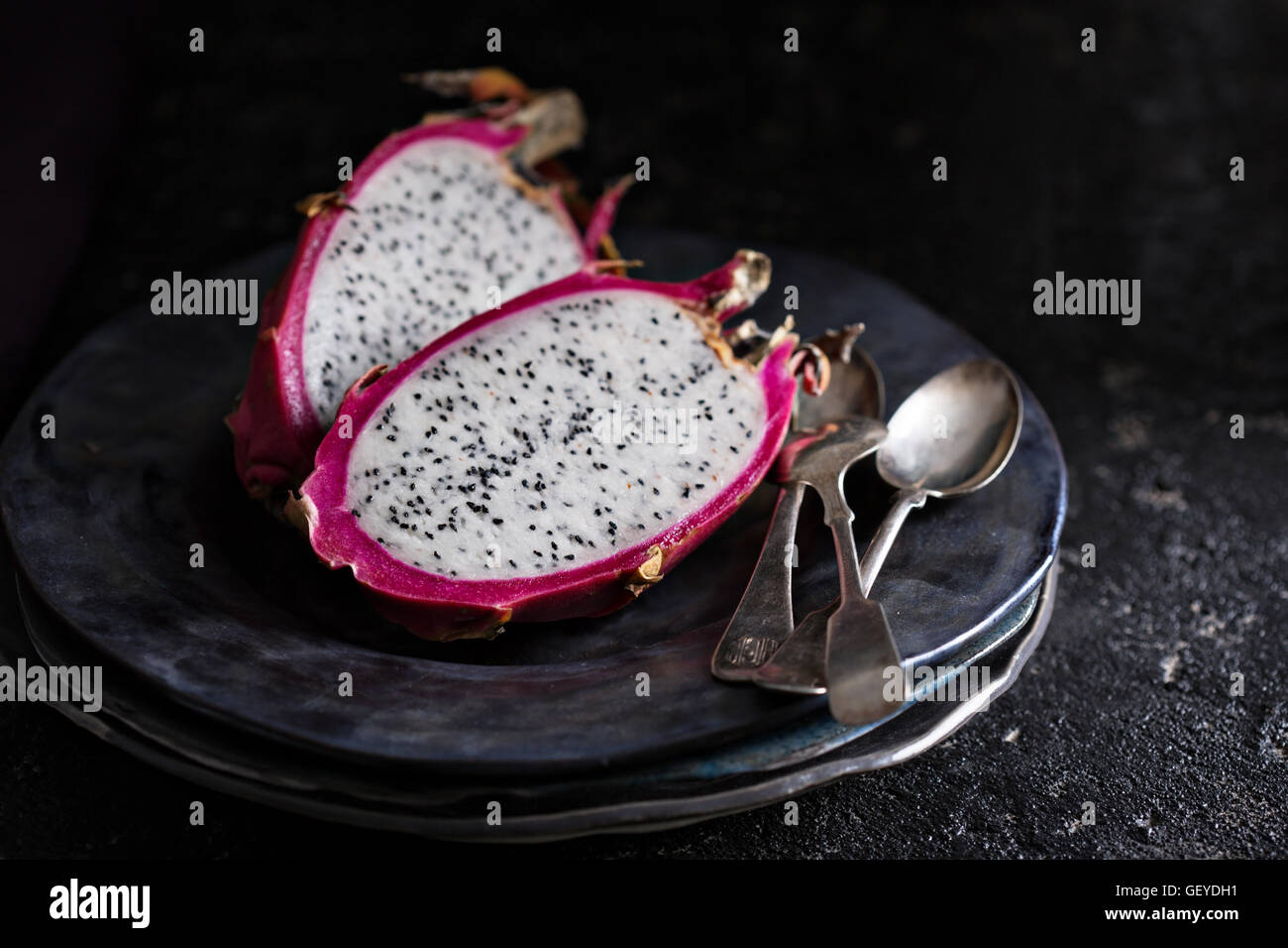 Dragon fruit cut open on a plate Stock Photo