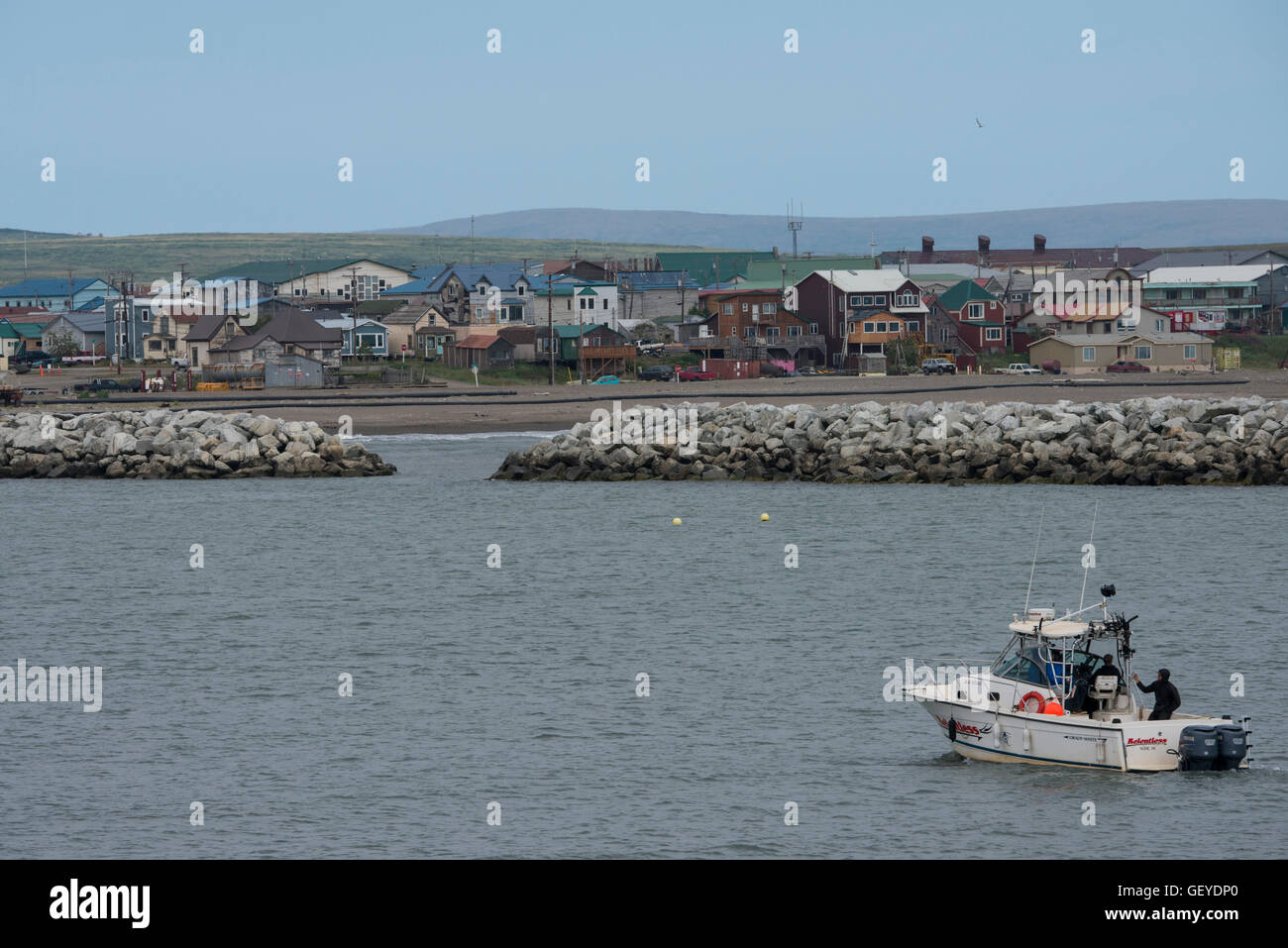 Alaska, Nome. Fishing boat in front of Bering Sea view of downtown Nome